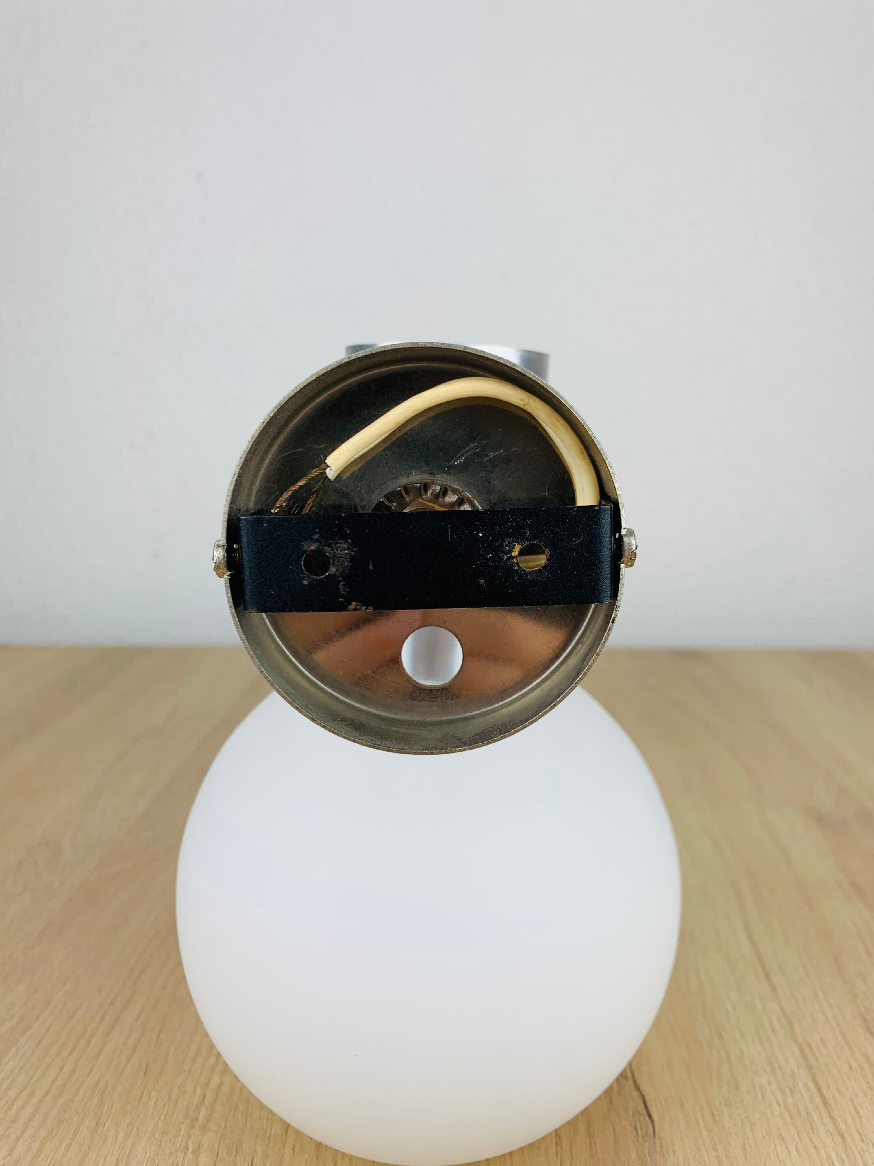 Space age opaline globe wall light, adjustable, and brushed metal, 1960s.