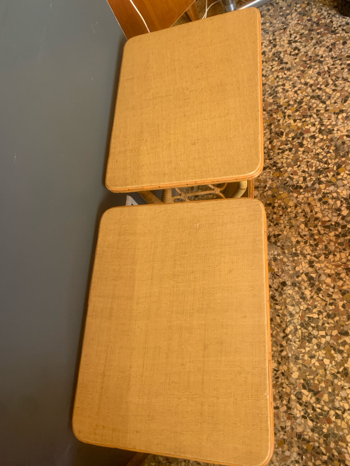 A pair of rattan bedside tables.
