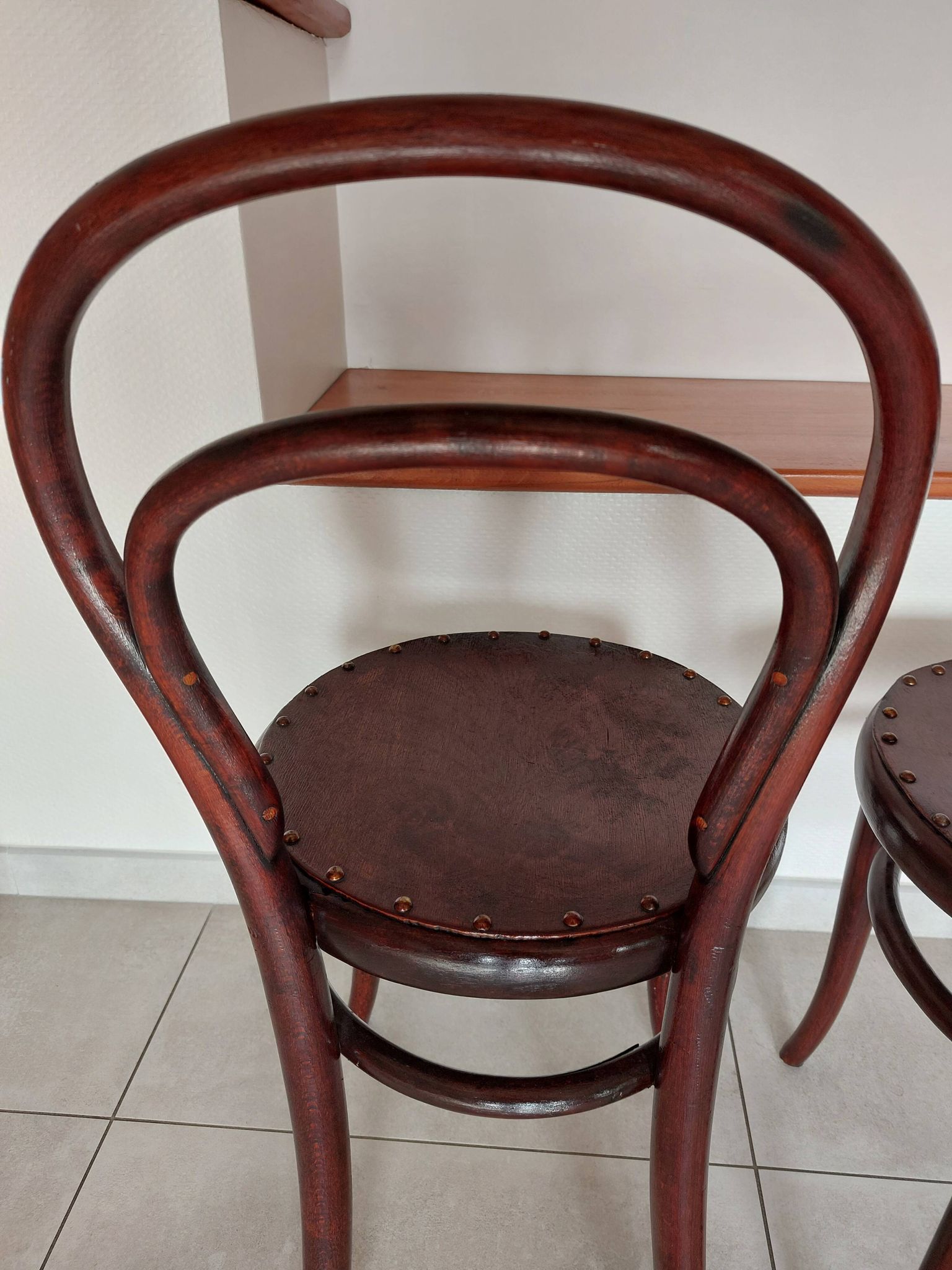 pair of round bistro chairs with a pattern on the seat, vintage