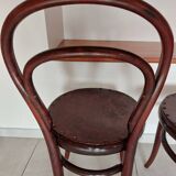 pair of round bistro chairs with a pattern on the seat, vintage