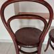 pair of round bistro chairs with a pattern on the seat, vintage