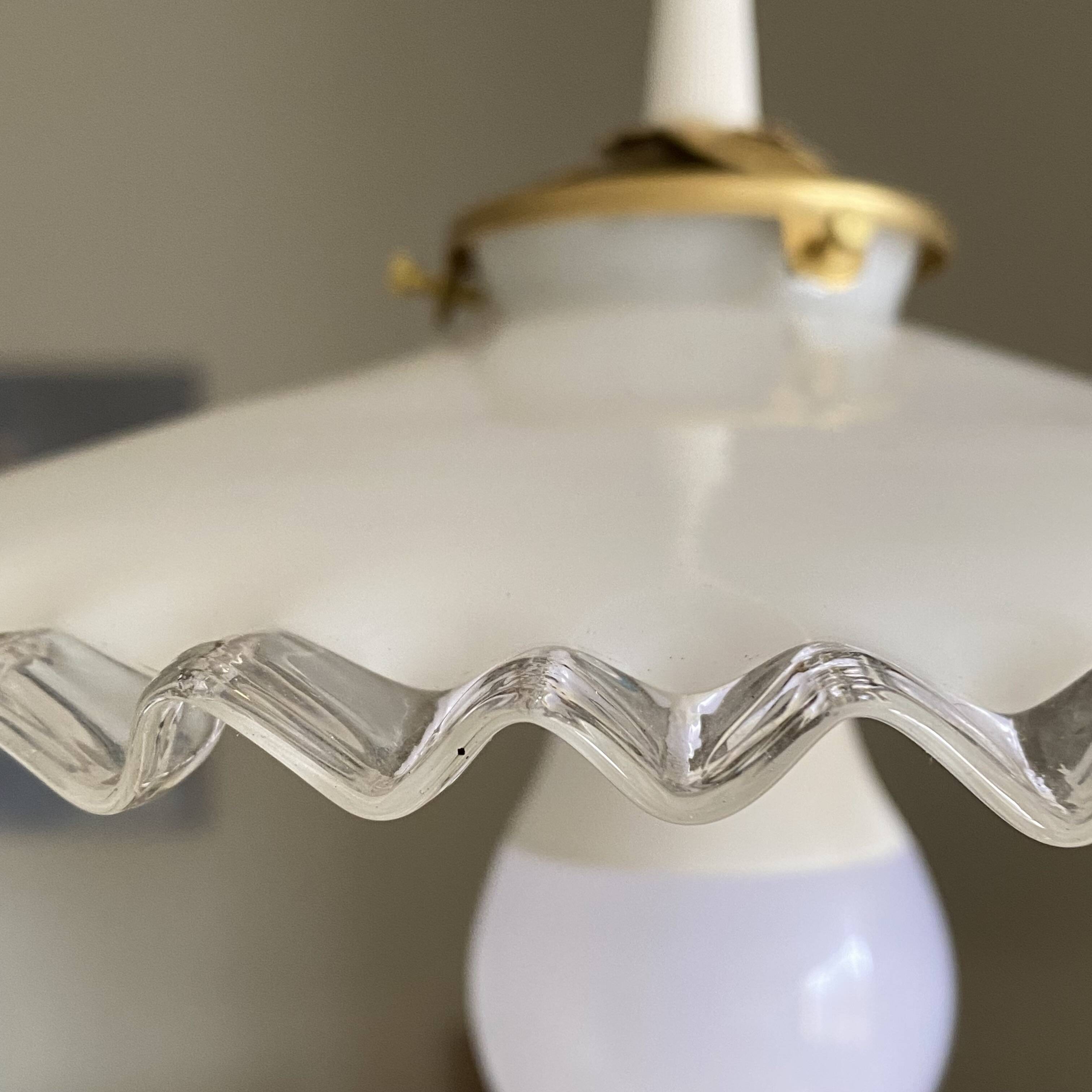 Old lampshade in white opaline glass with a wavy edge.