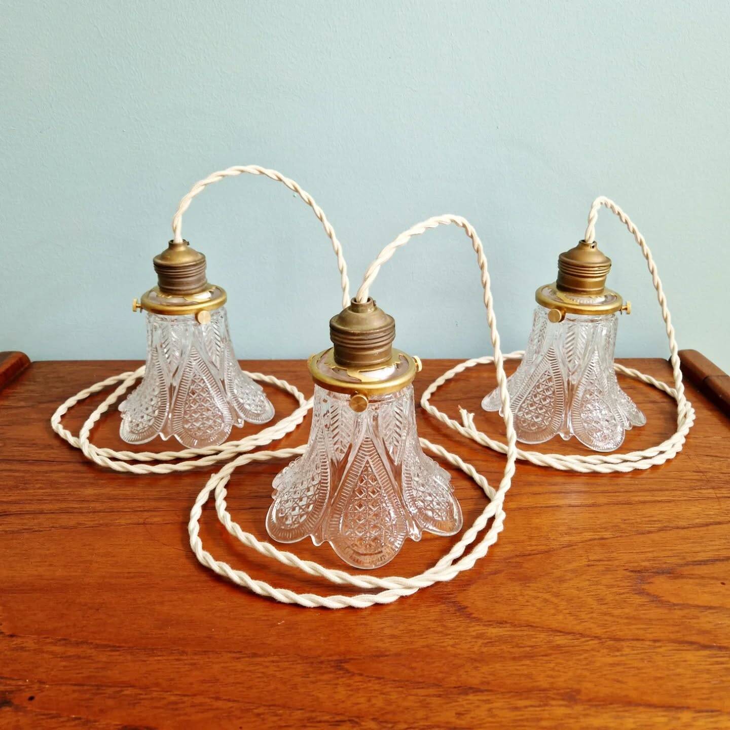 Art Deco trio of pendant lights/table lamps in clear glass, 1920s-30s.