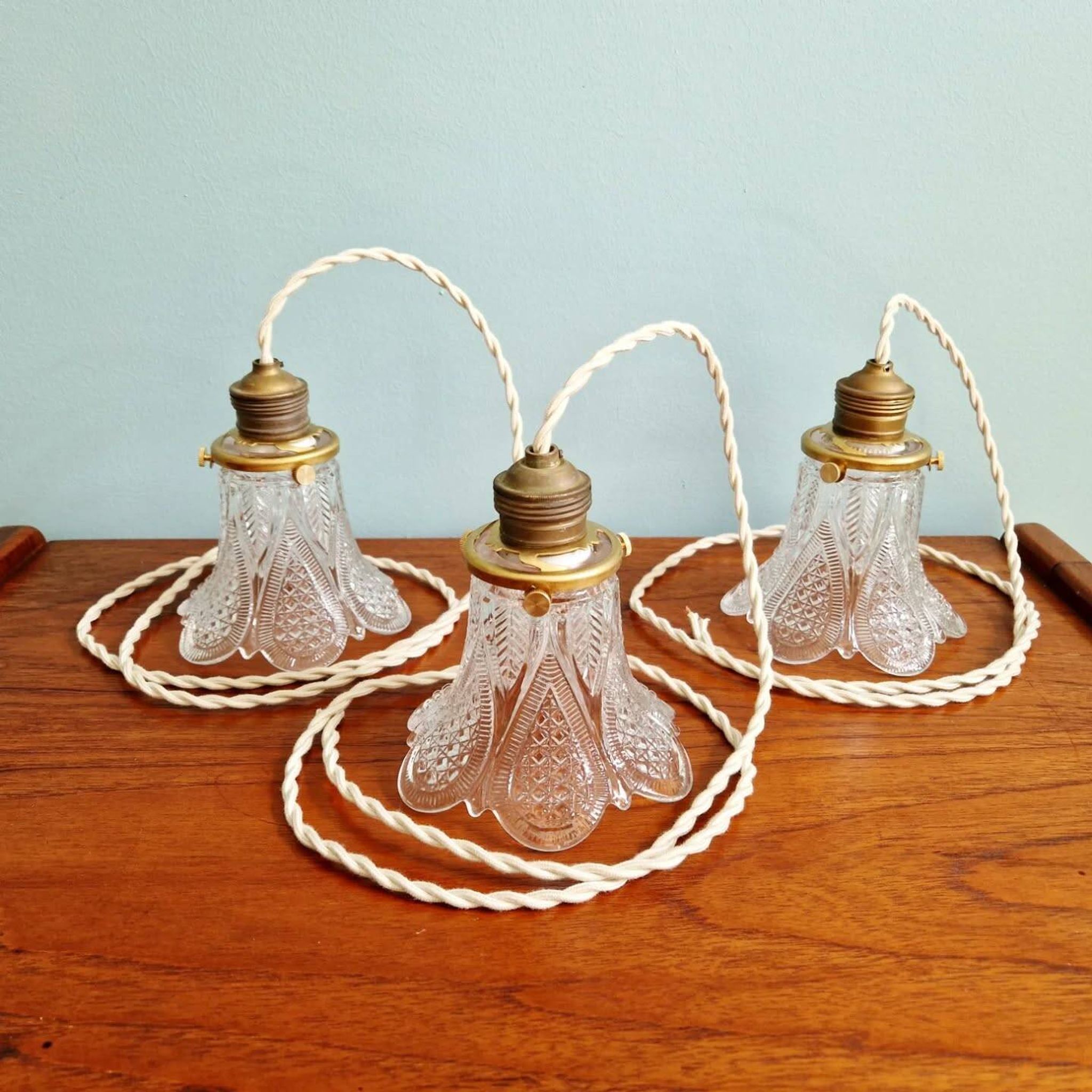 Art Deco trio of pendant lights/table lamps in clear glass, 1920s-30s.
