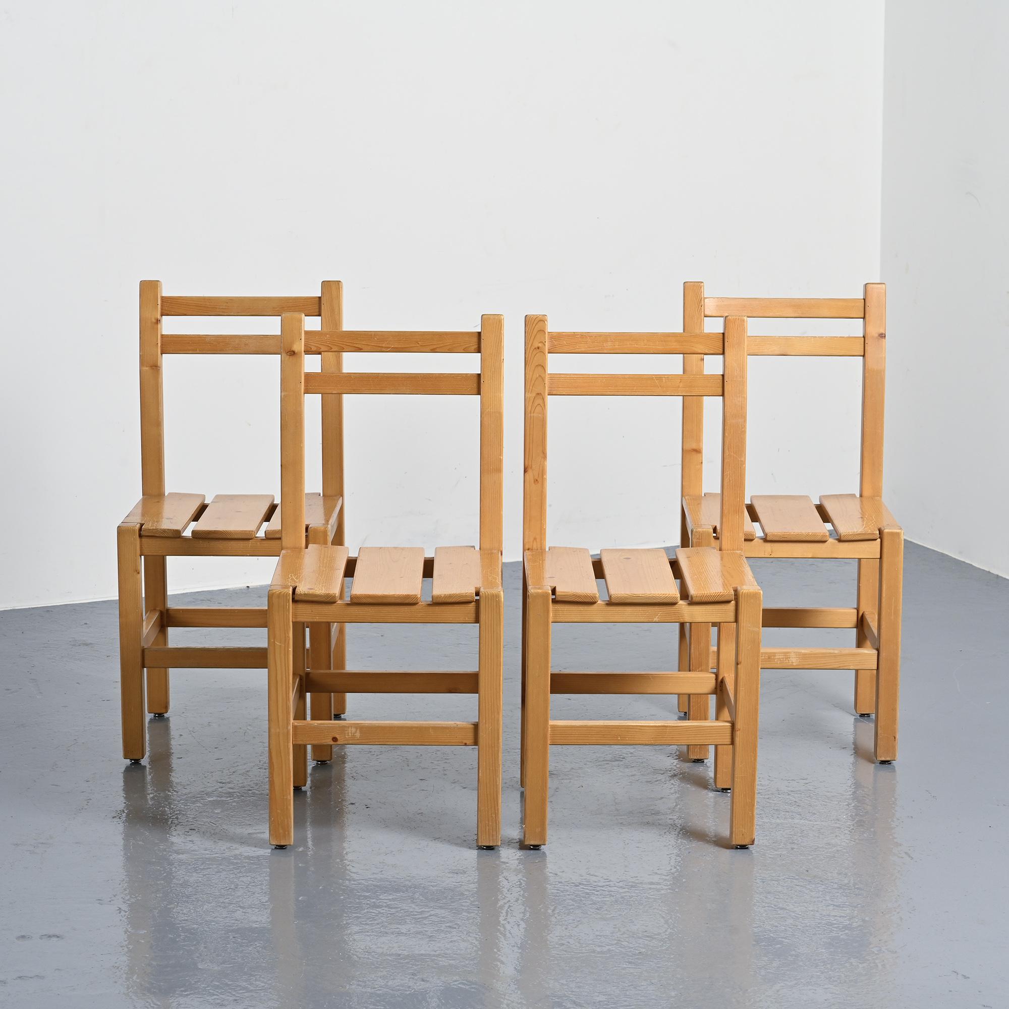 Set of four solid pine chairs by Maison Regain.