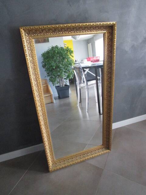 Large old mirror in wood and gilded stucco