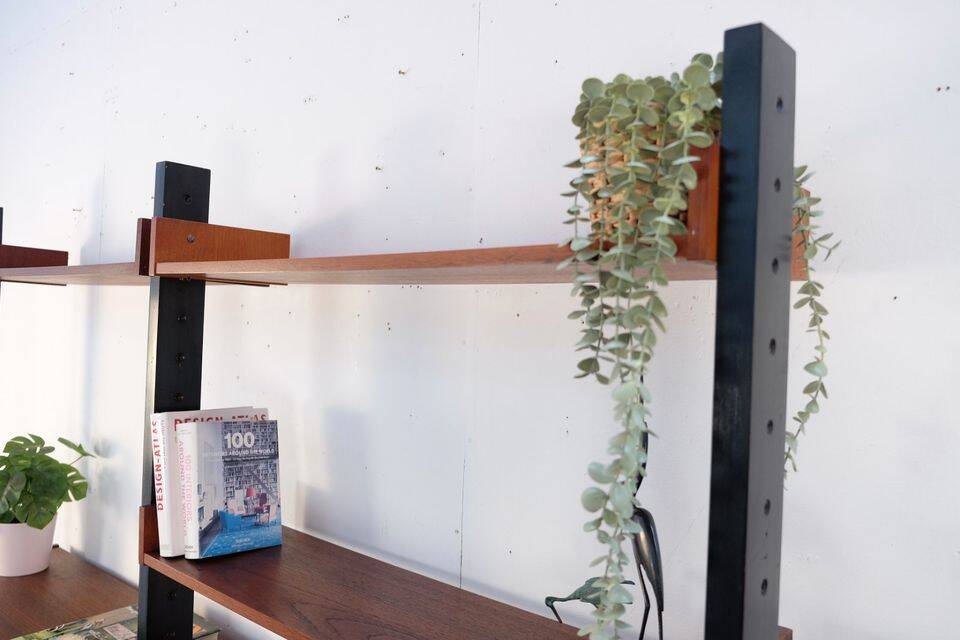 Vintage teak shelving system in 60s-70s style, retro style.