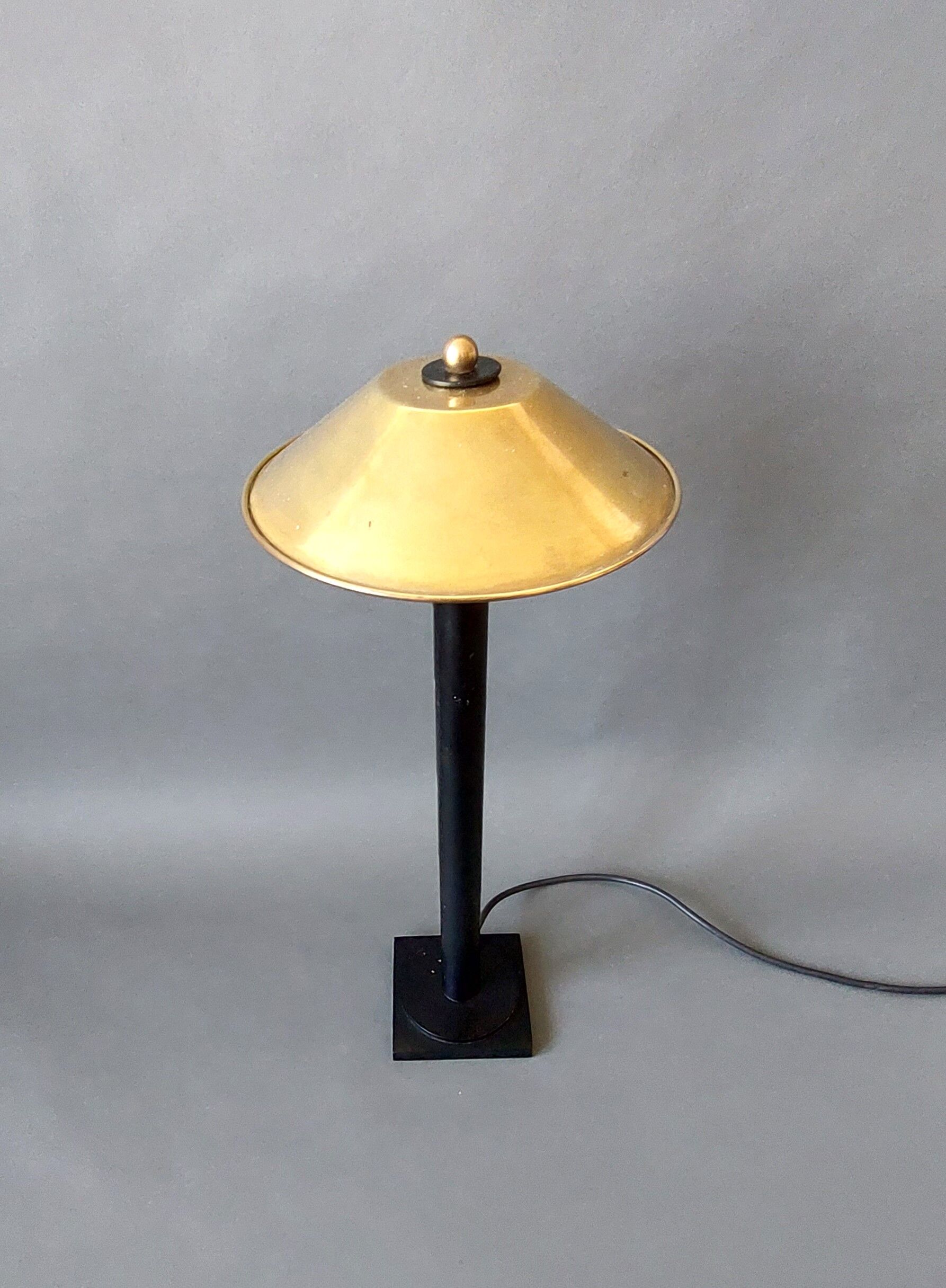 Post-Modern lamp in black metal and gilded brass.