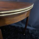 A Louis XVI period mahogany half-moon table forming a console/games table