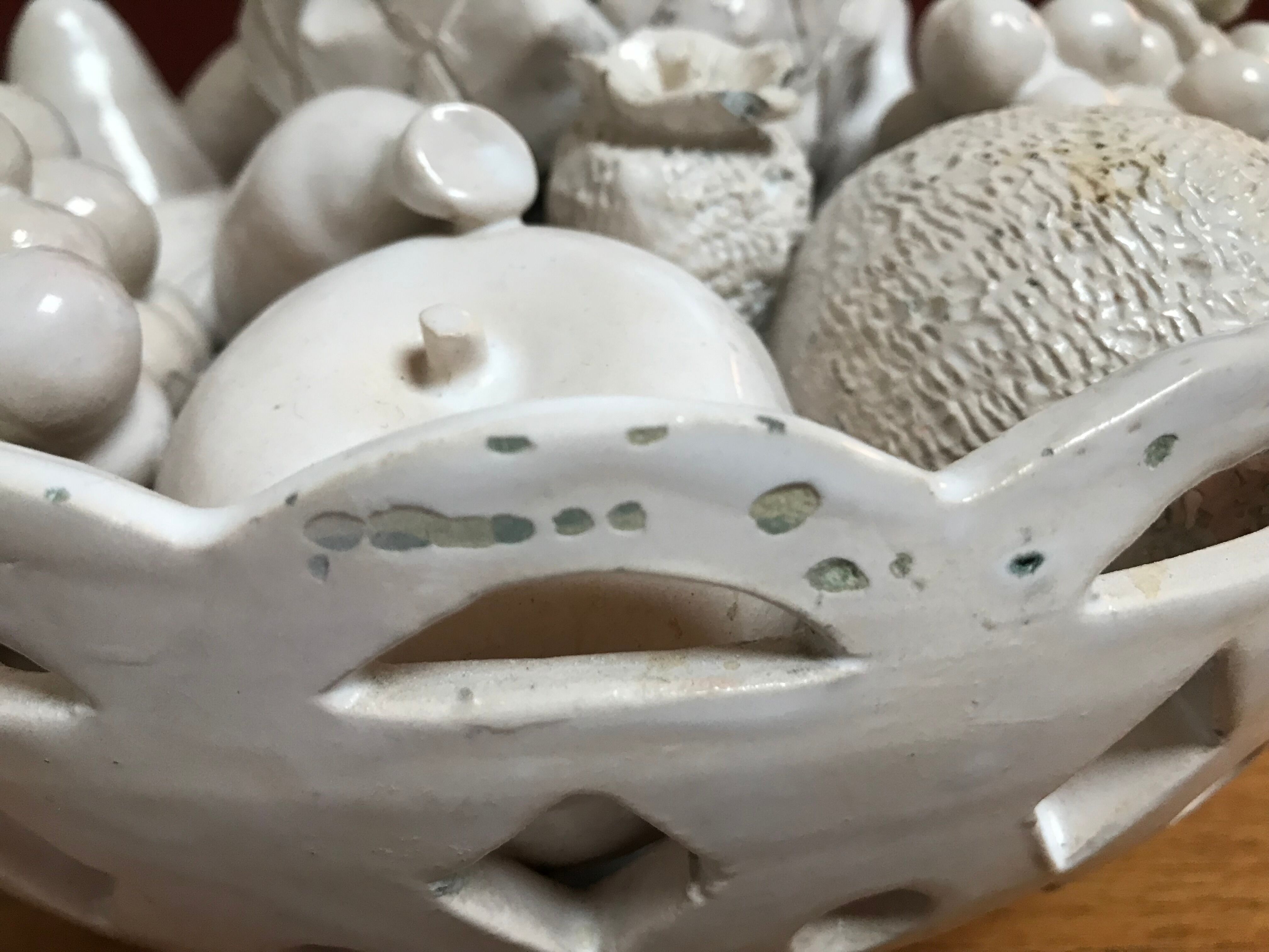 Trompe l'oeil fruit cut in white earthenware by Jean Roger, circa 1960.