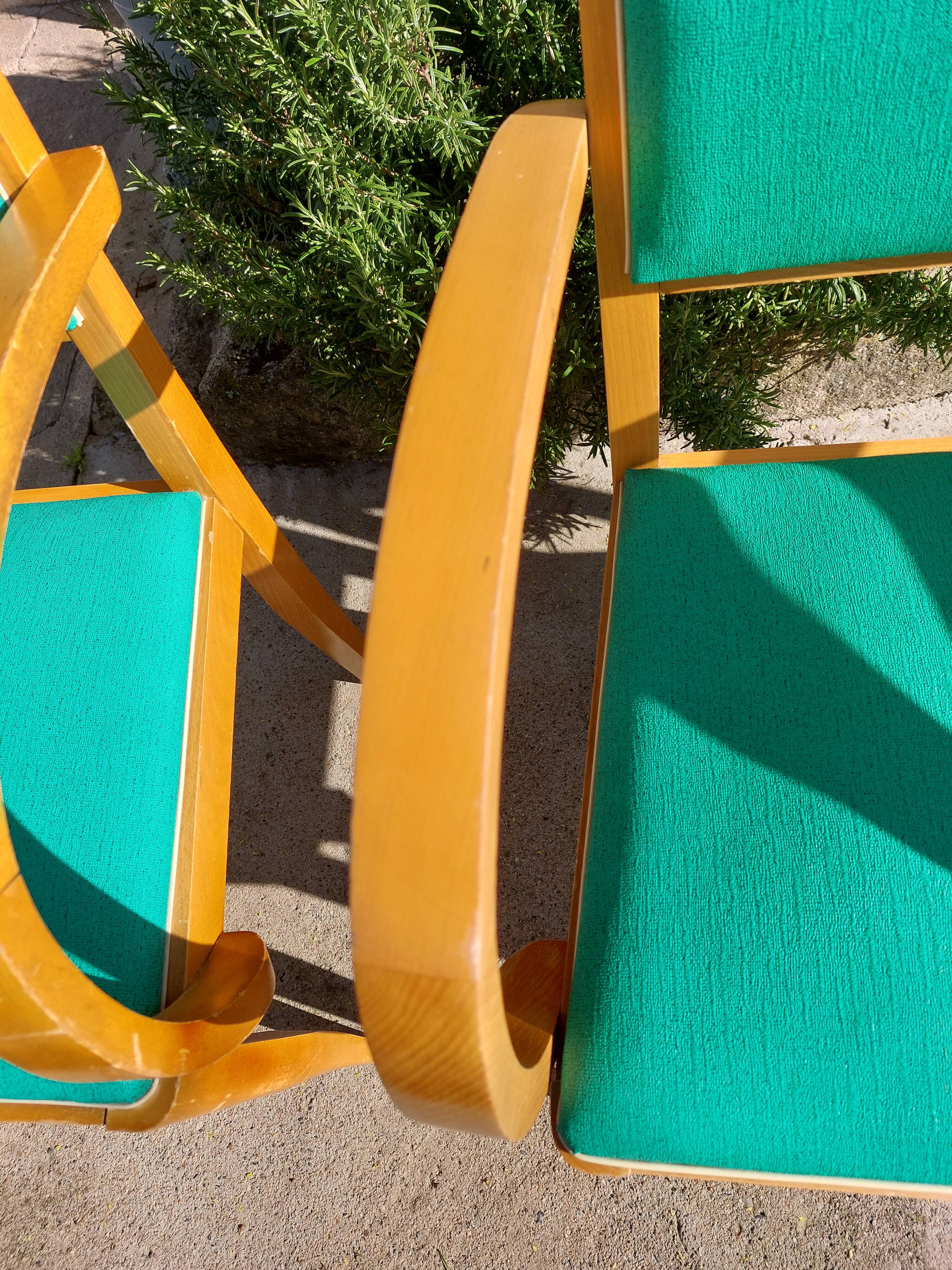 3 vintage bridge chairs with rounded armrests.