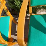3 vintage bridge chairs with rounded armrests.
