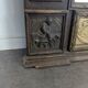 Renaissance-style mirror in wood and copper with a craftsmanship theme.