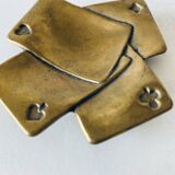 Empty pocket square of aces in brass