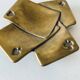 Empty pocket square of aces in brass