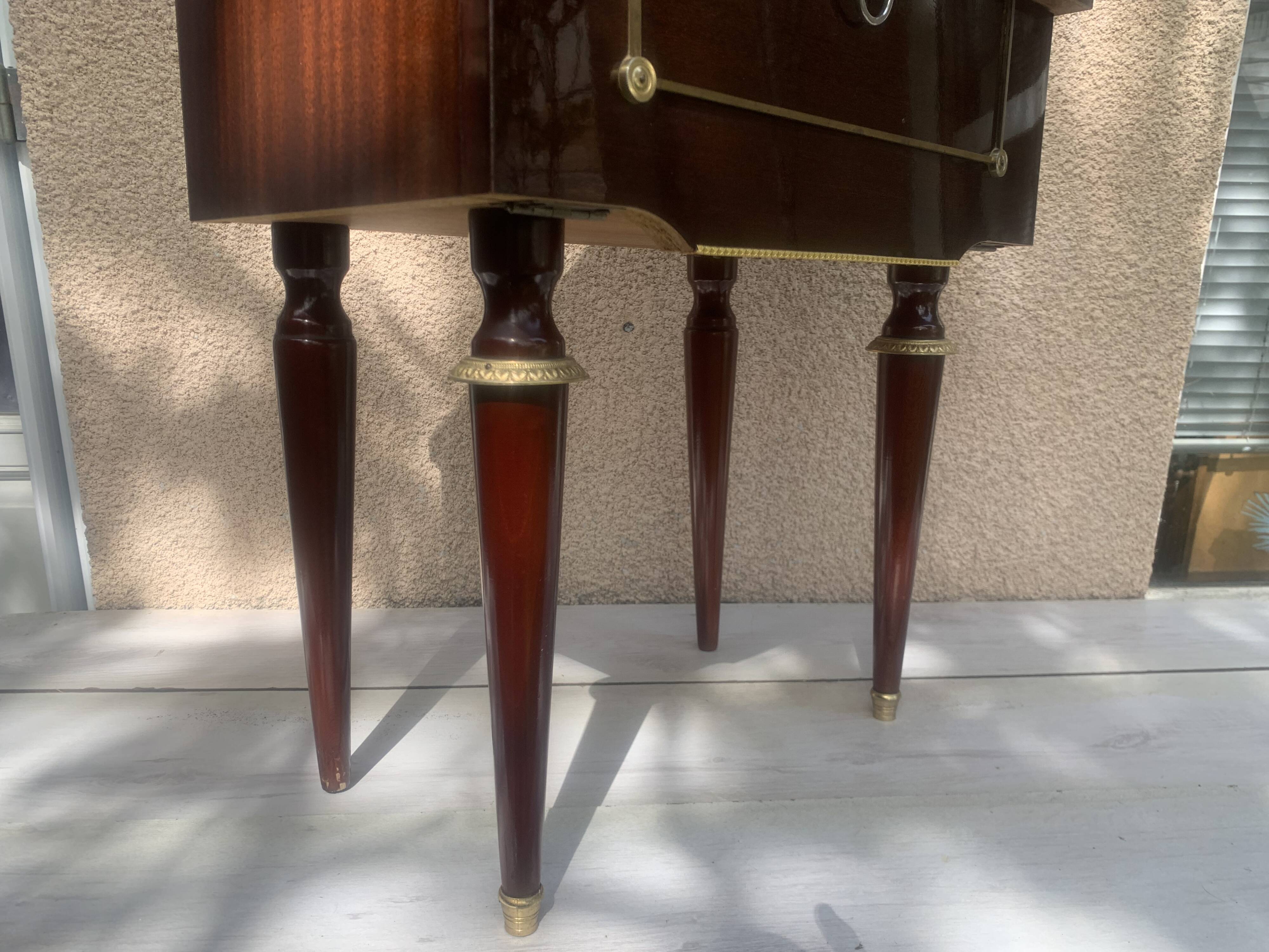 Nightstand with lovely mid-century style gold metal decor.