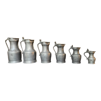 Series of 6 antique pewter pitchers