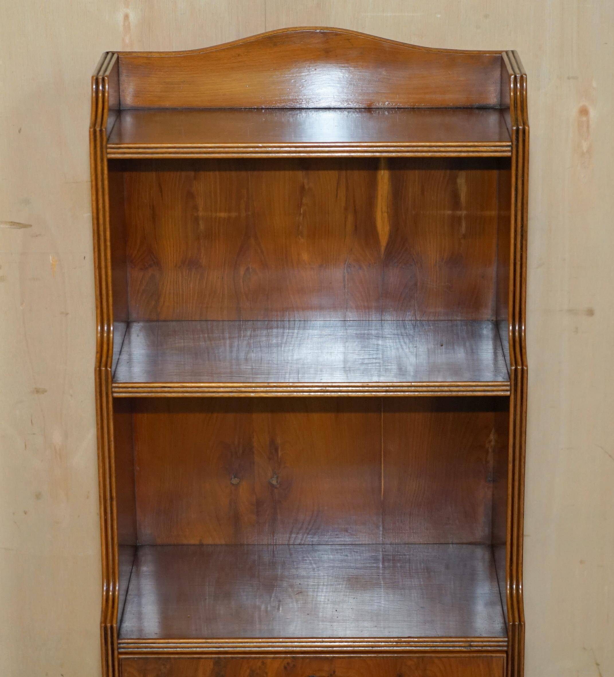 Pair of vintage English hardwood bookcases in a cascade style with cupboards.