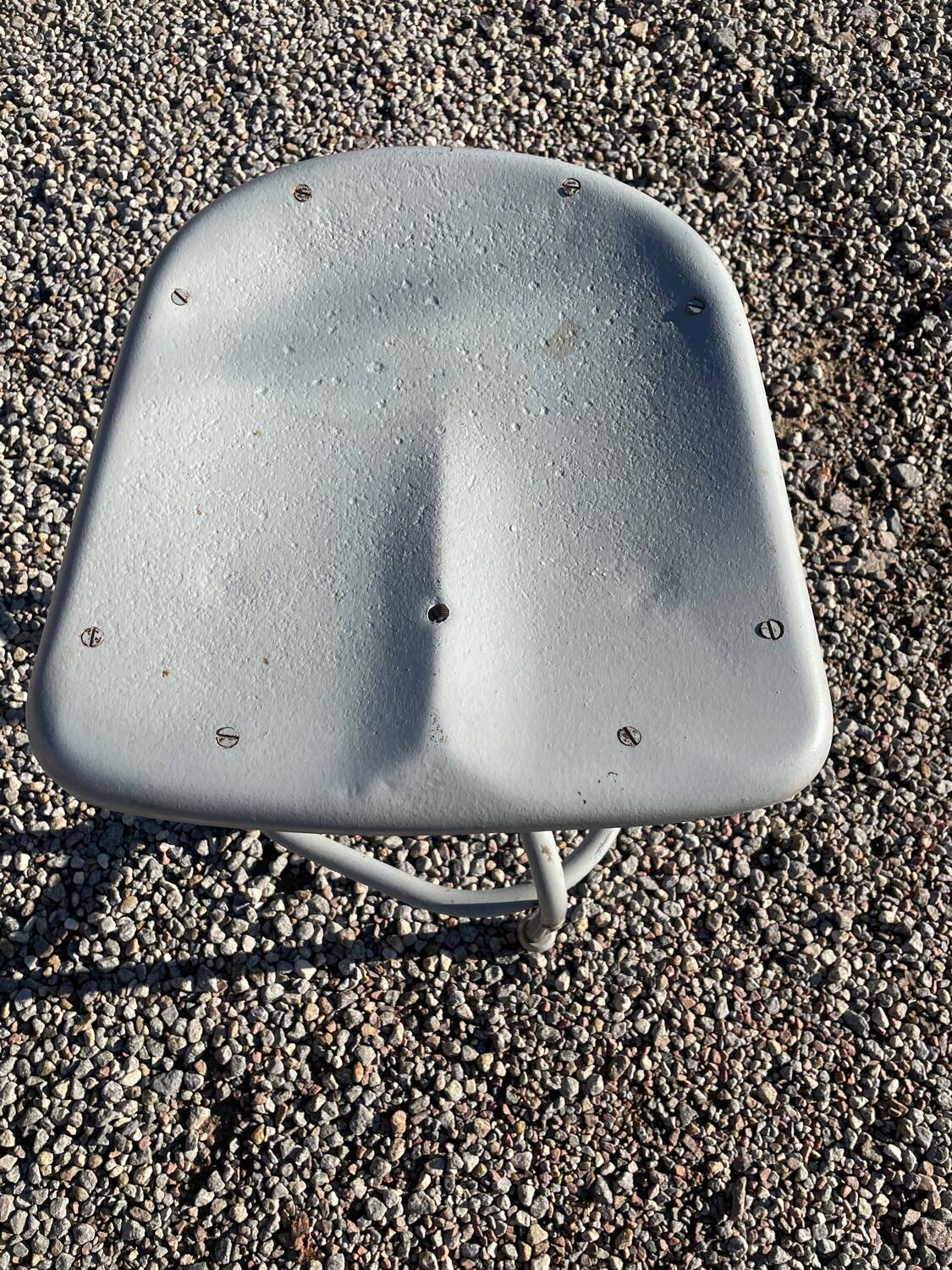 Old metal stool from a factory industrial workshop