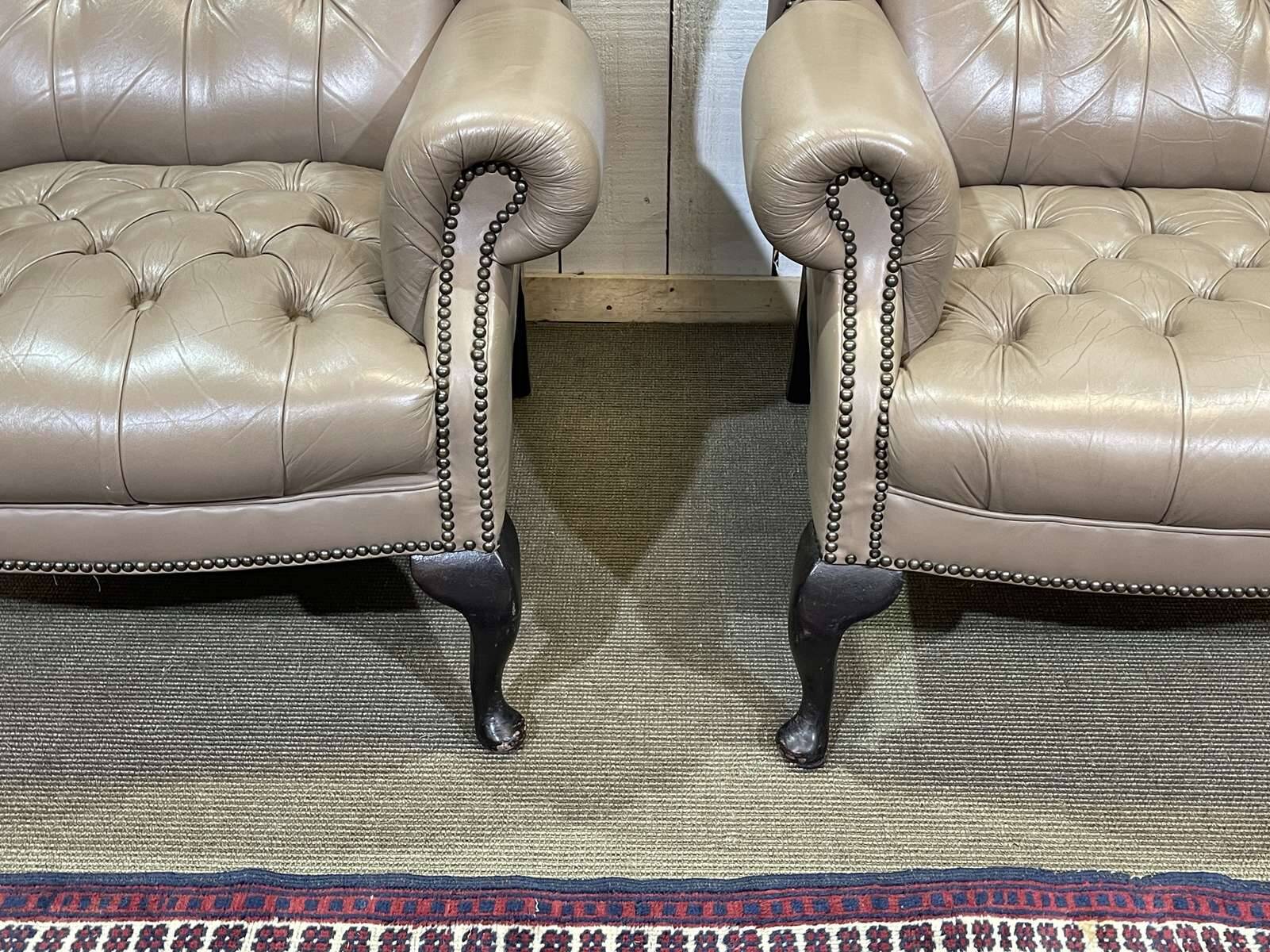 Pair of high-backed Chesterfield armchairs with 1 leather footrest