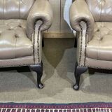 Pair of high-backed Chesterfield armchairs with 1 leather footrest