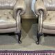 Pair of high-backed Chesterfield armchairs with 1 leather footrest