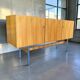 Vintage wooden storage cabinet with chrome legs