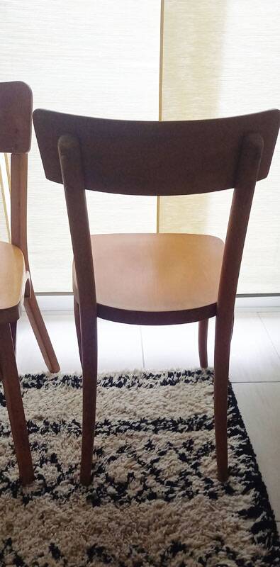Set of 4 light wood bistro chairs stamped Baumann and Thonet.