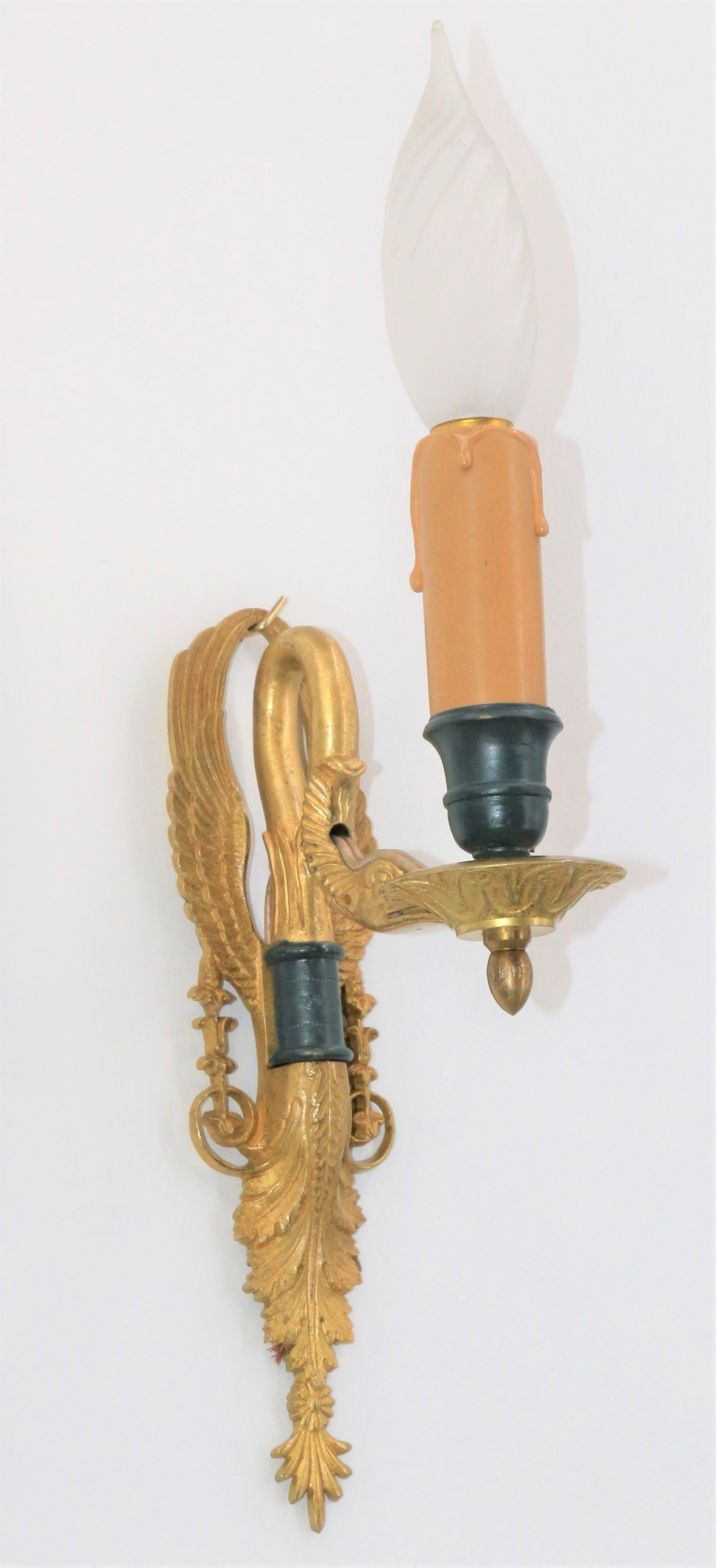 Pair of golden bronze wall lamps in triumphant empire swan style