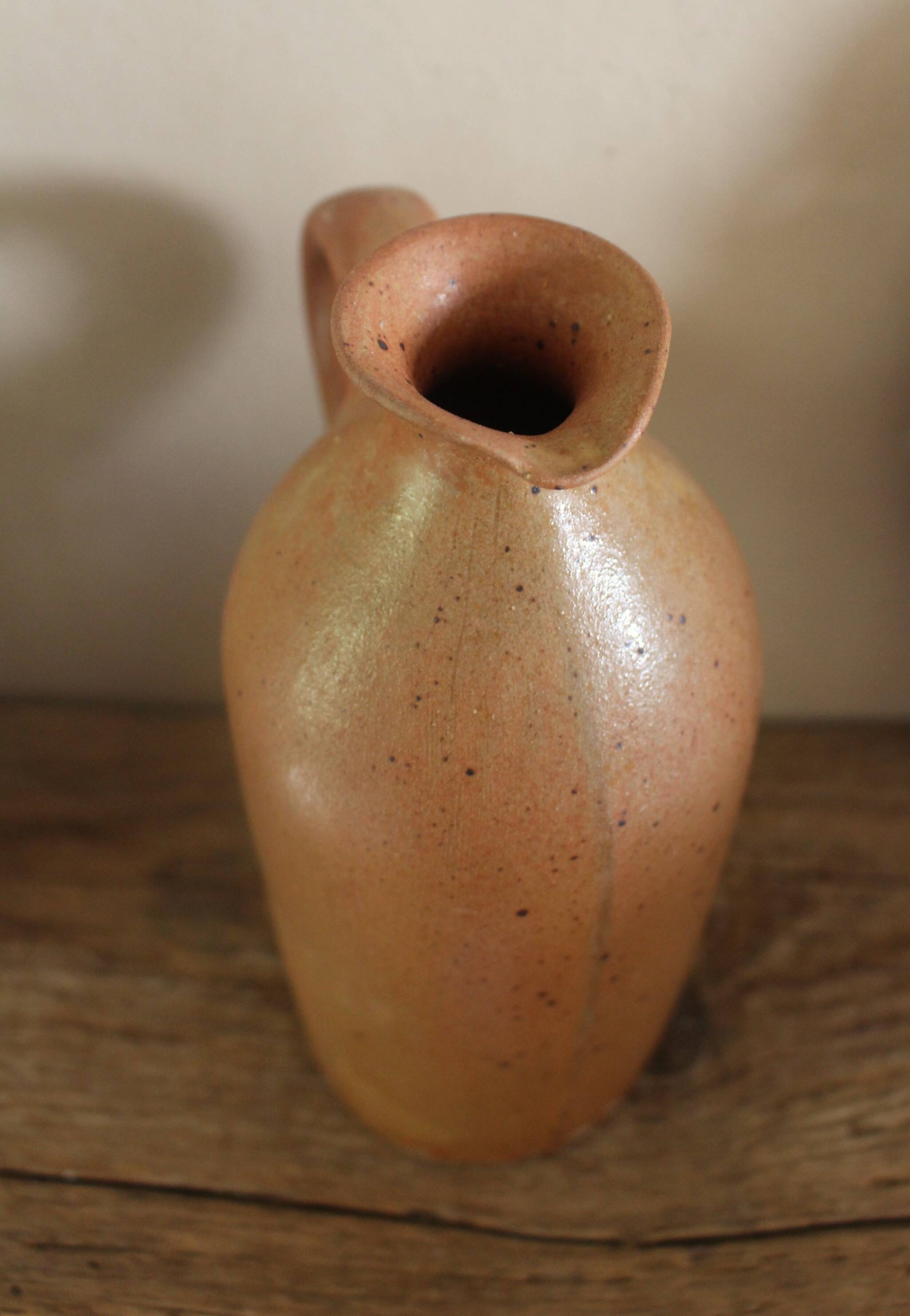Vintage stoneware liqueur bottle with handle