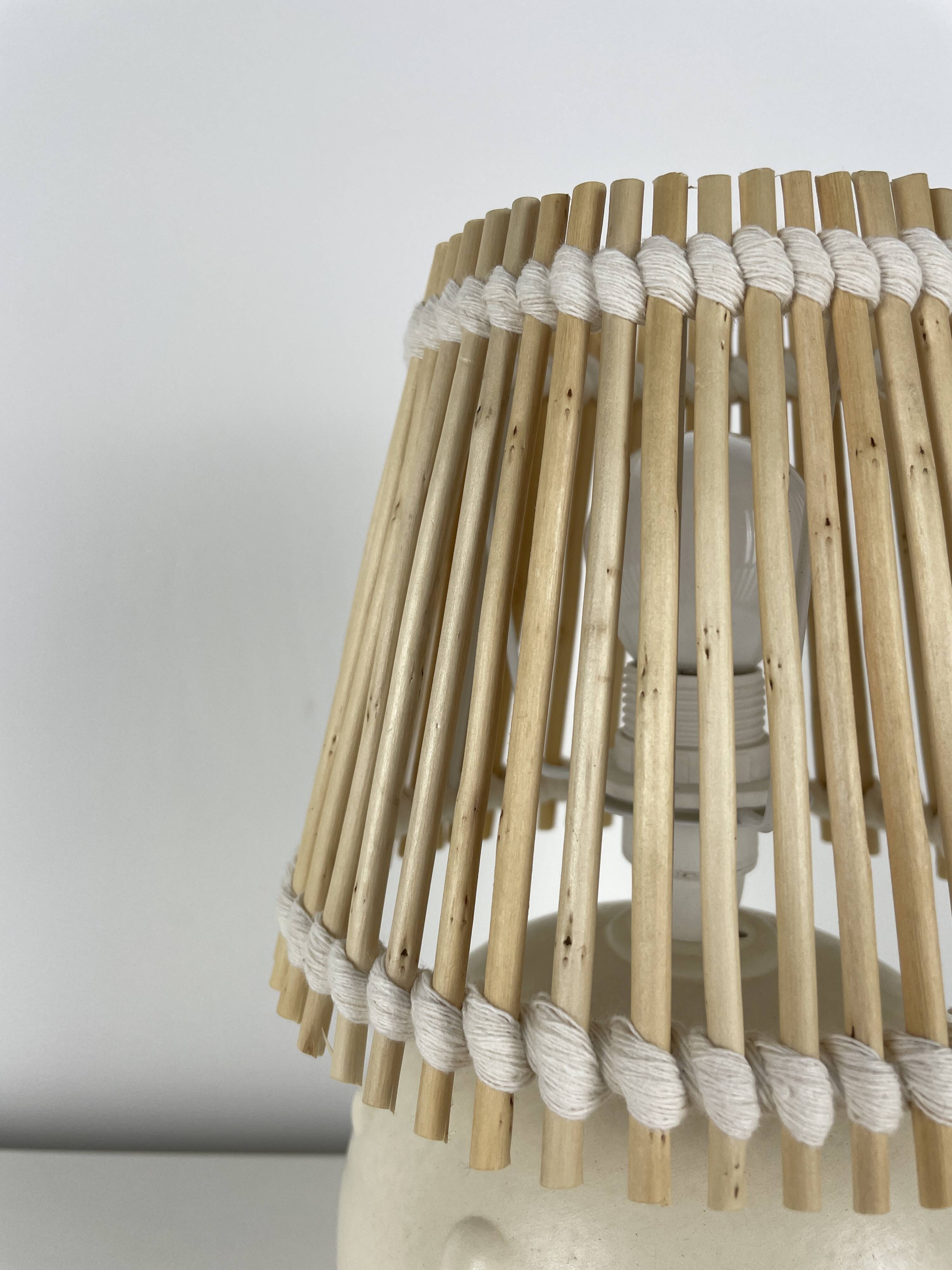 Vintage ceramic lamp with wicker and cotton shade.