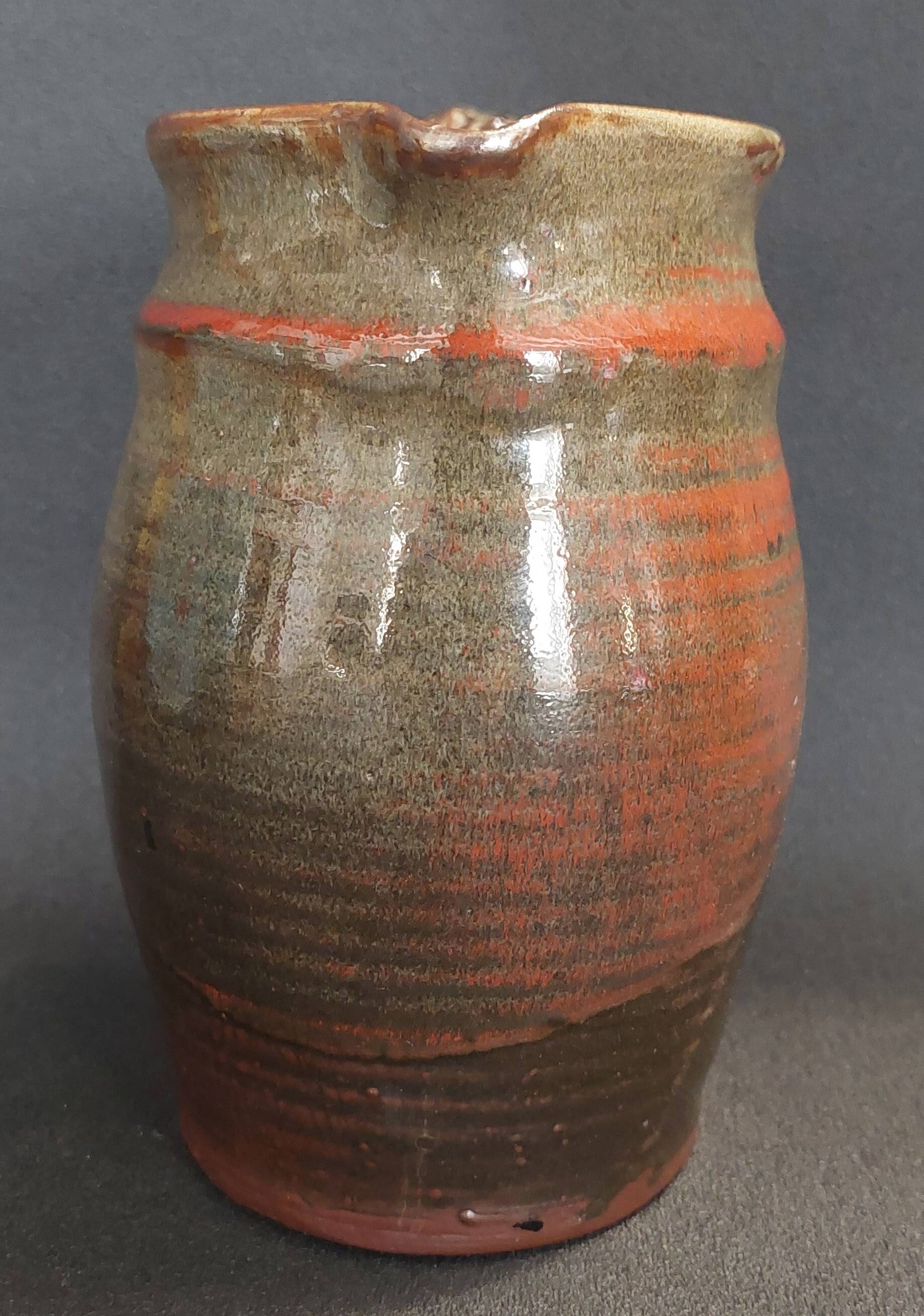Ceramic pitcher from the 20th century with a signature to identify.