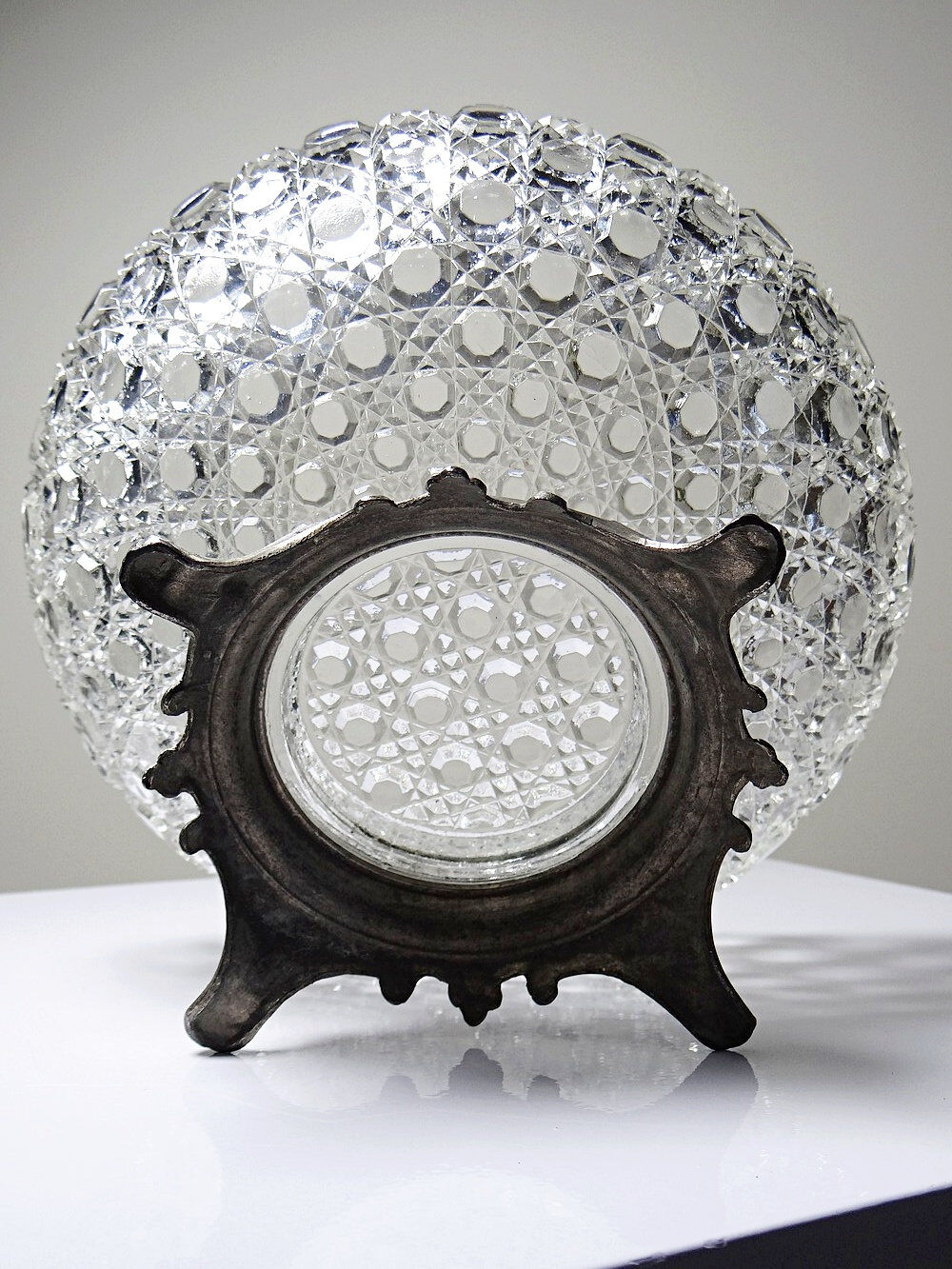 Pressed glass coupe with diamond points, antique from 1920-1950 on a pewter base.