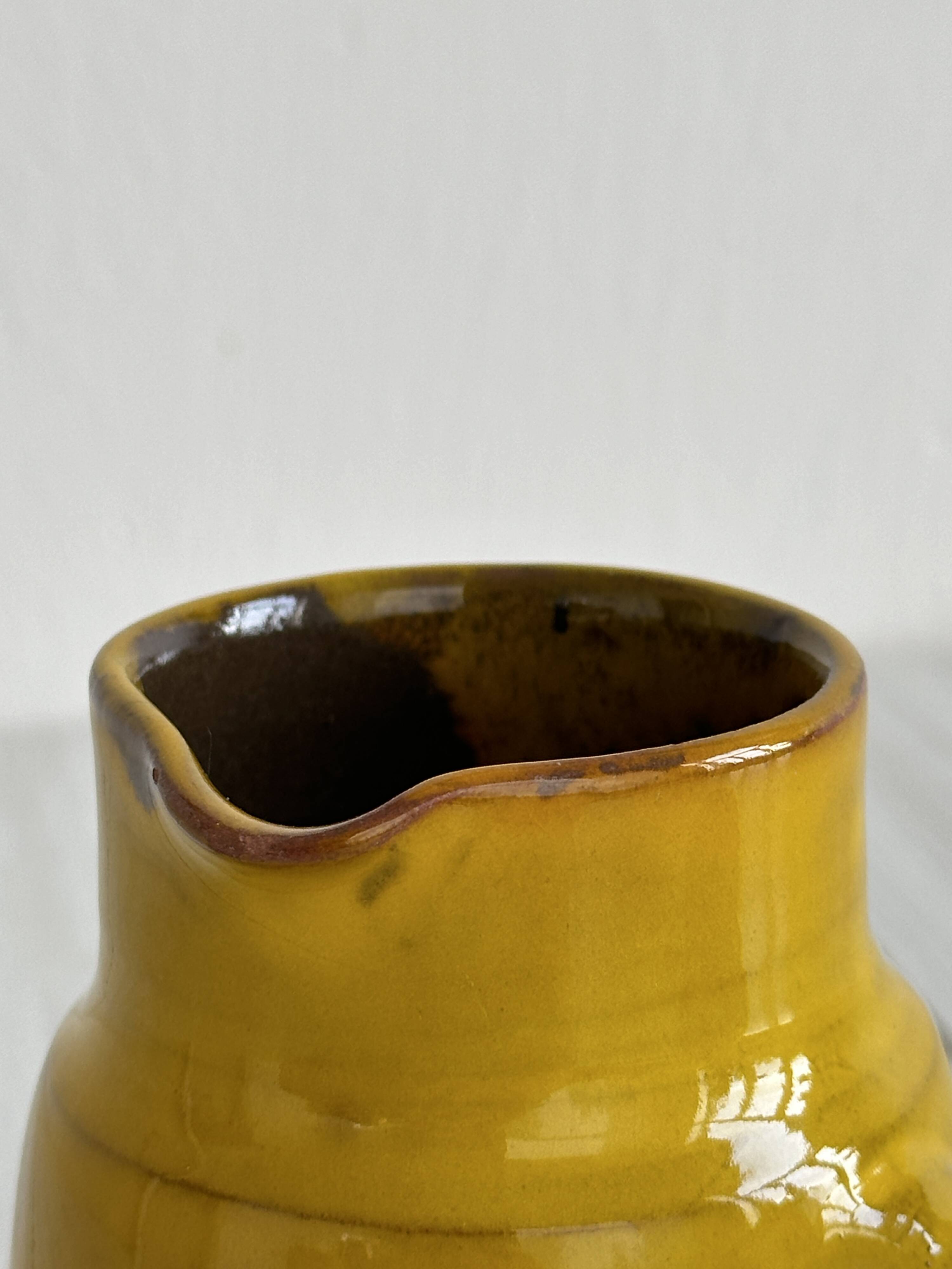 Yellow glazed ceramic sauce boat or milk jug