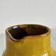 Yellow glazed ceramic sauce boat or milk jug