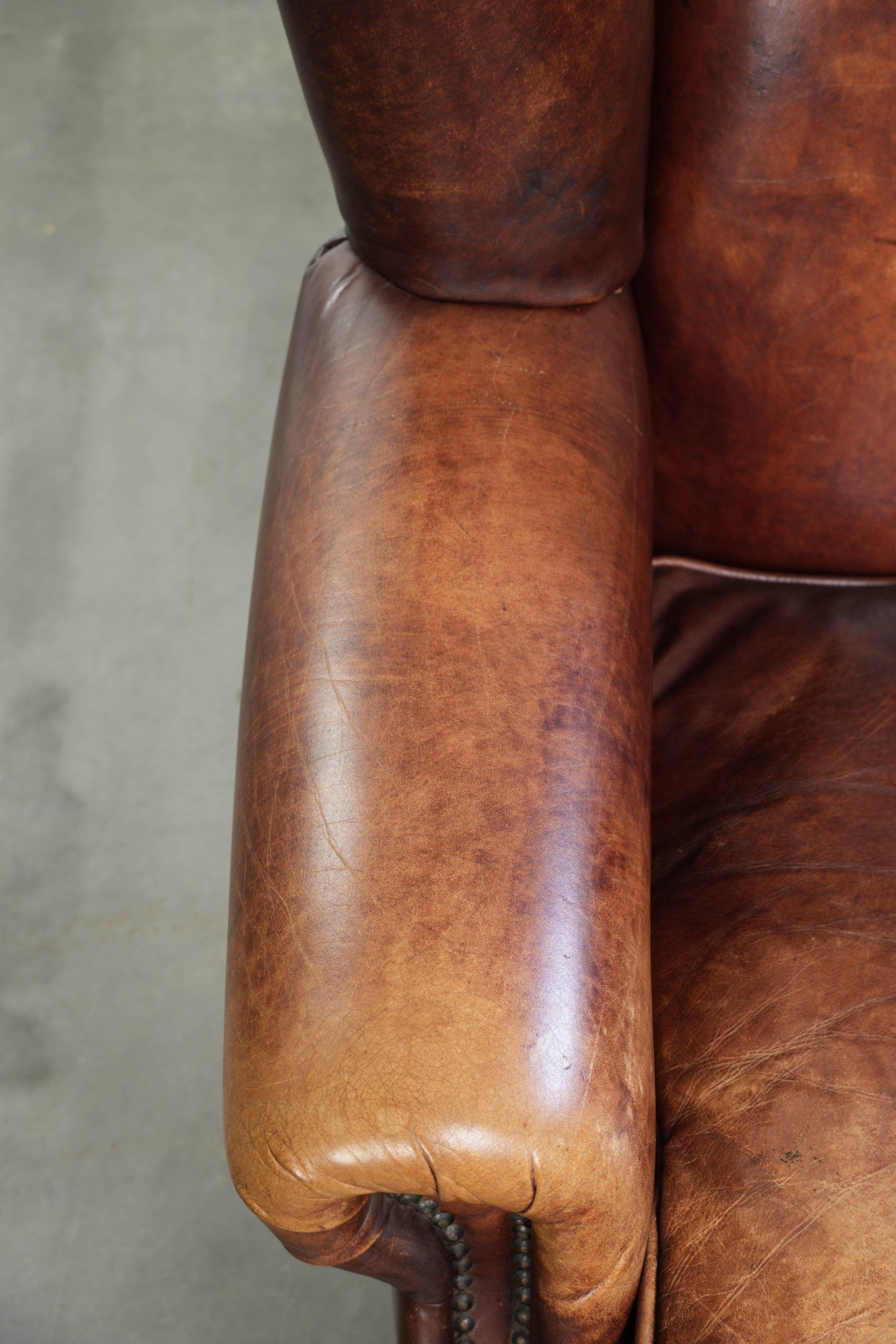 Comfortable cowhide wingback armchair in English style