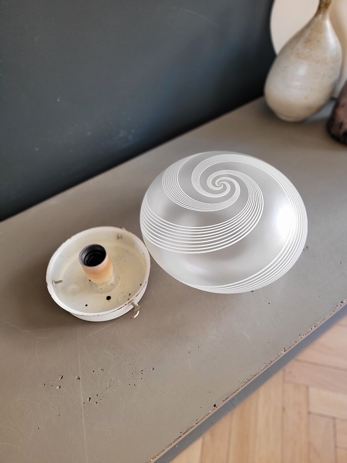 Frosted glass globe ceiling light with spiral patterns.
