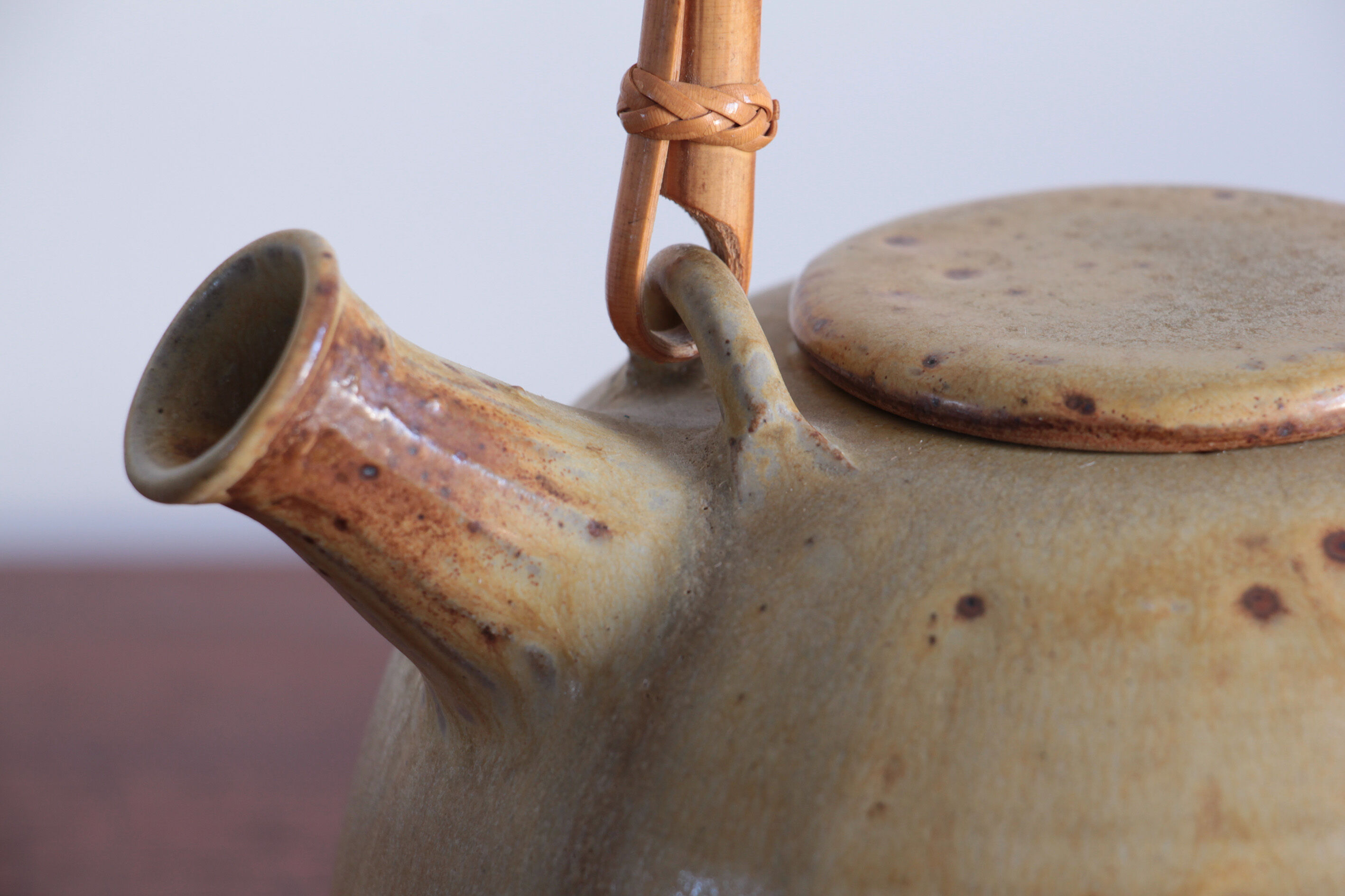 Sandstone teapot with rattan handle