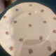 Dessert plate and porcelain dishes with a multicoloured floral pattern, vintage.