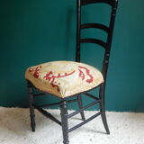 Black Napoleon III chair lined with phoenix