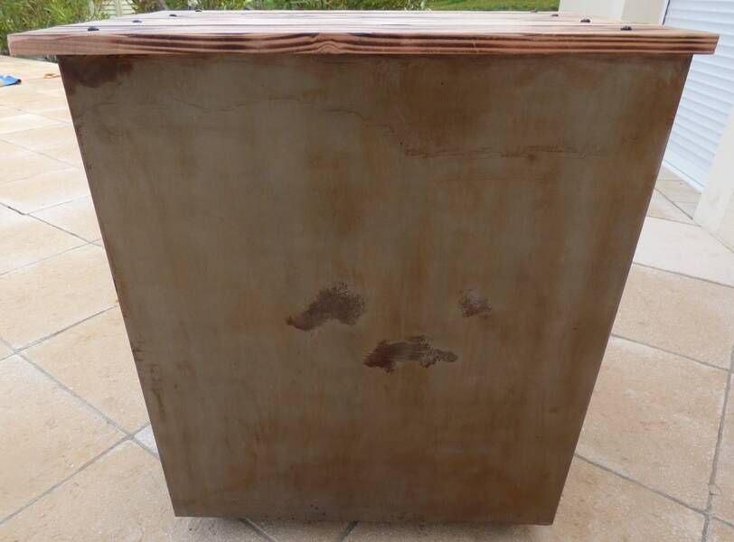 Vintage industrial metal furniture with a rusty effect, featuring two drawers on wheels.