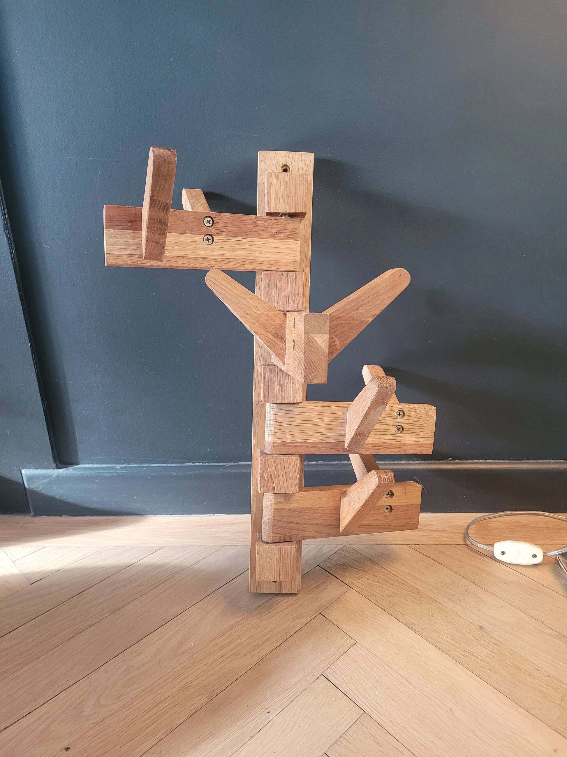 Articulated vertical wall coat rack