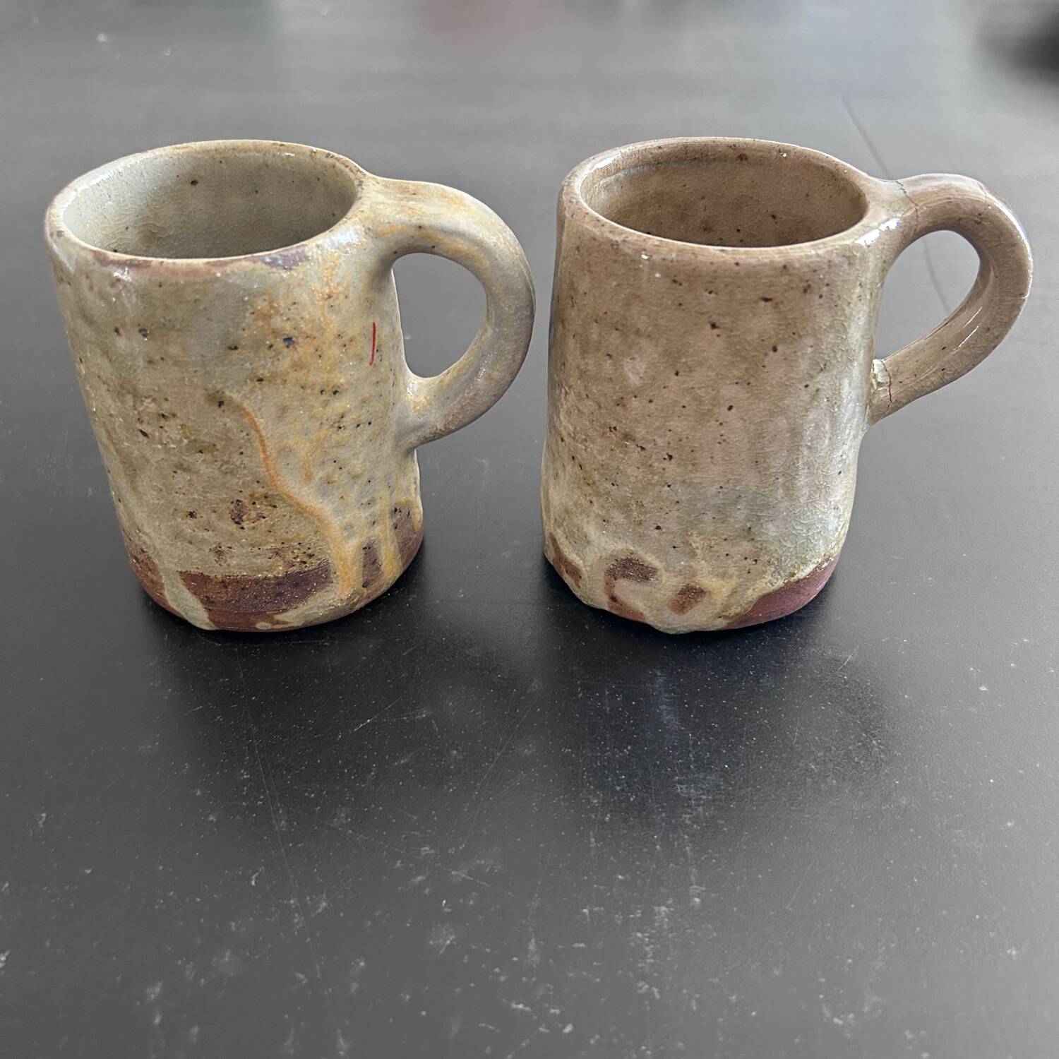 Pair of signed stoneware mugs