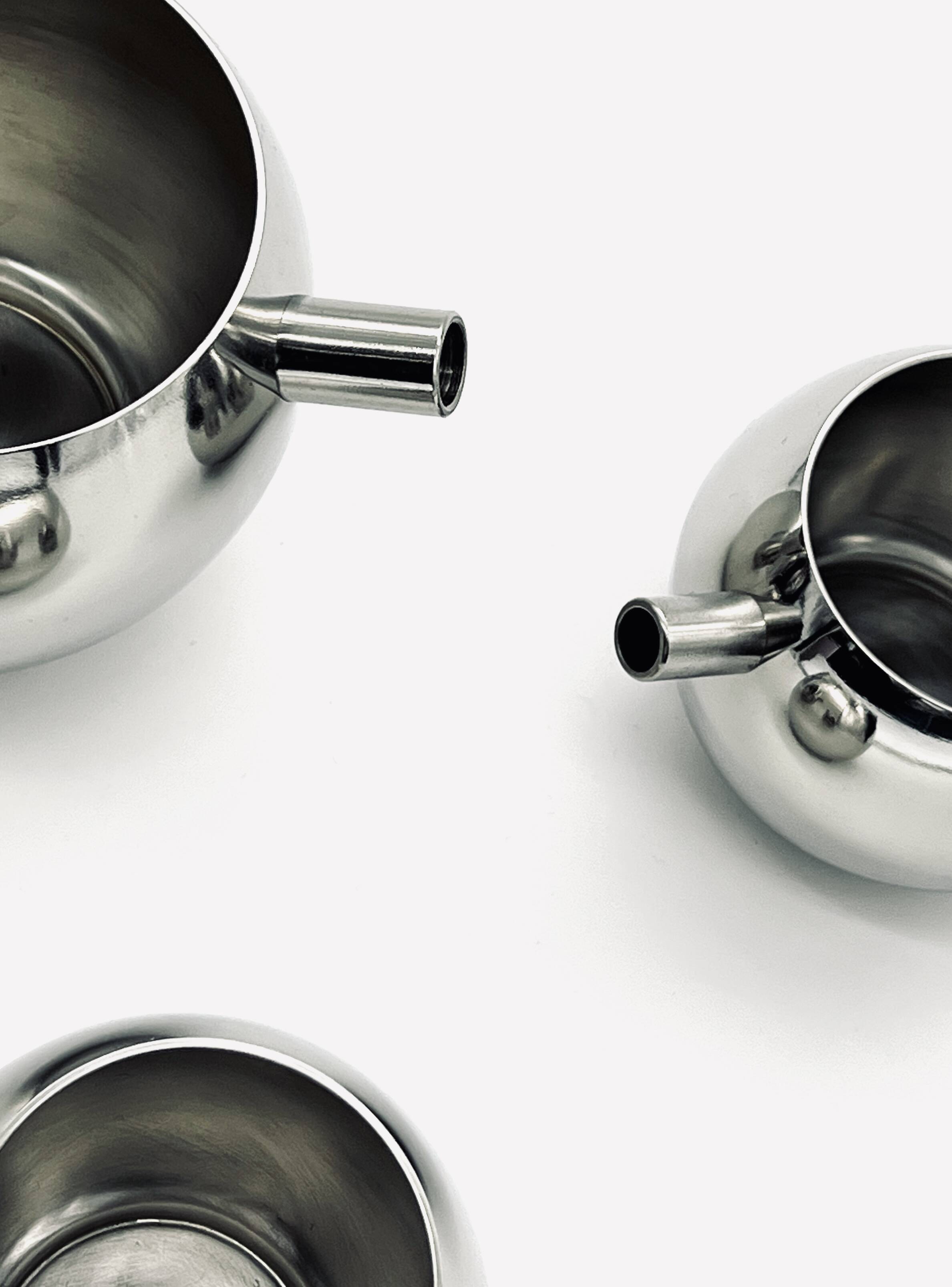Stainless steel teapot, milk jug and sugar bowl