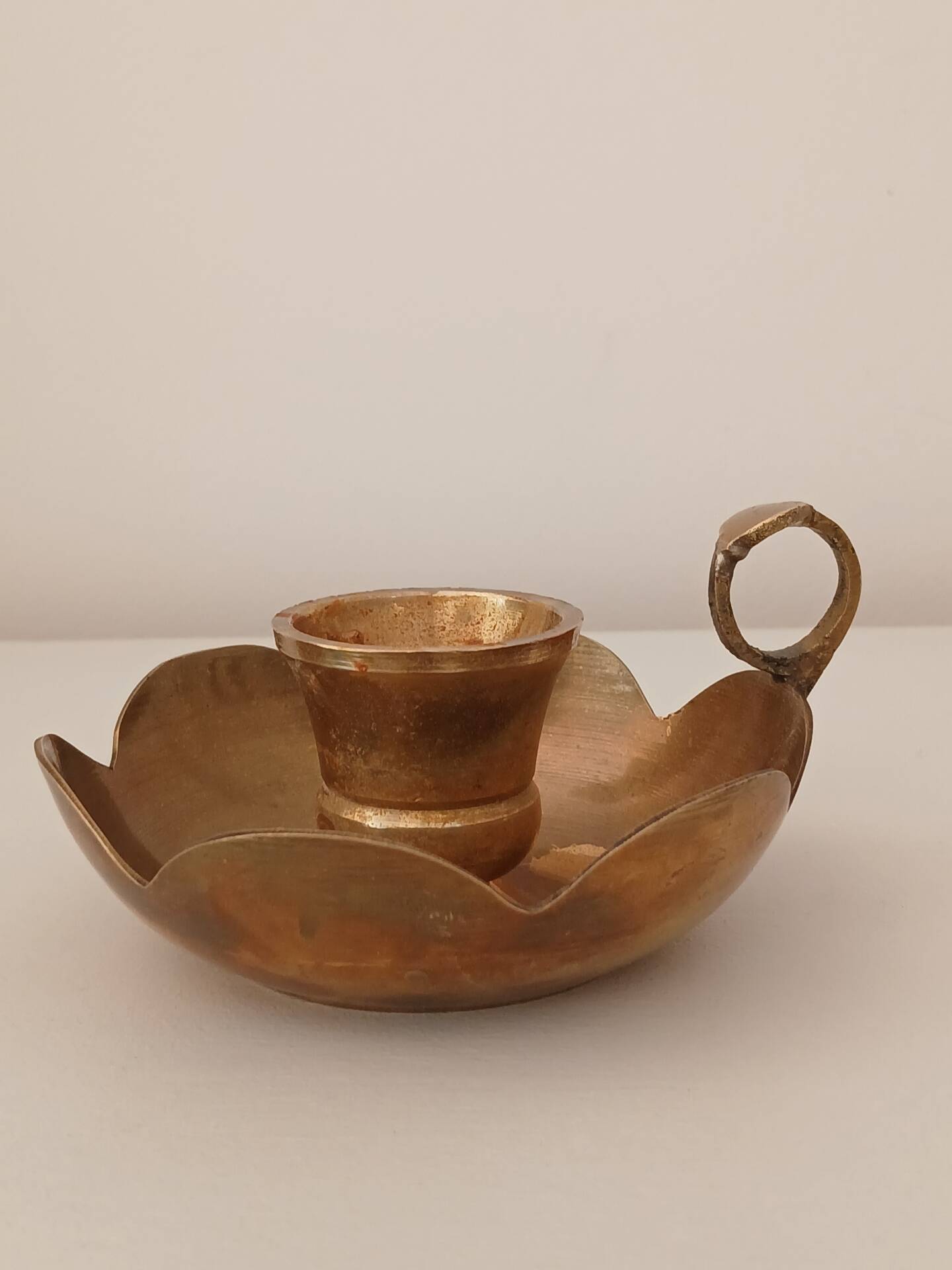 Brass candle holder in the shape of a flower.