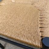 4 black Scandinavian chairs with solid wood and cord.