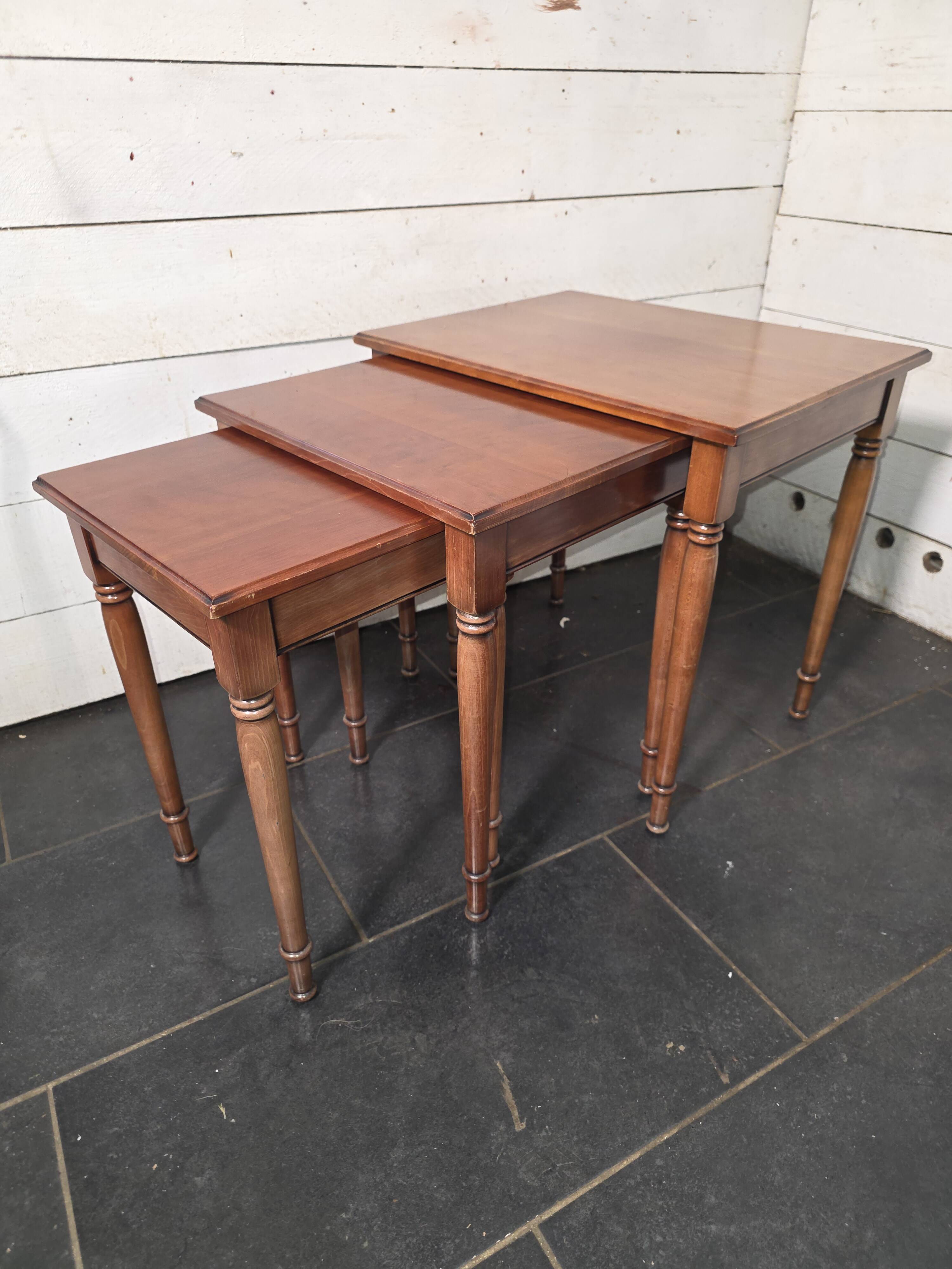 Nest of tables in solid cherry wood from the mid-20th century.