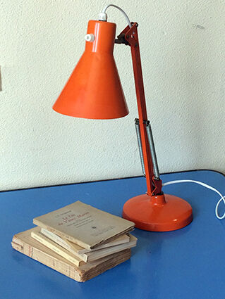 Luxo L9 orange single-arm lamp on plinth