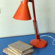 Luxo L9 orange single-arm lamp on plinth