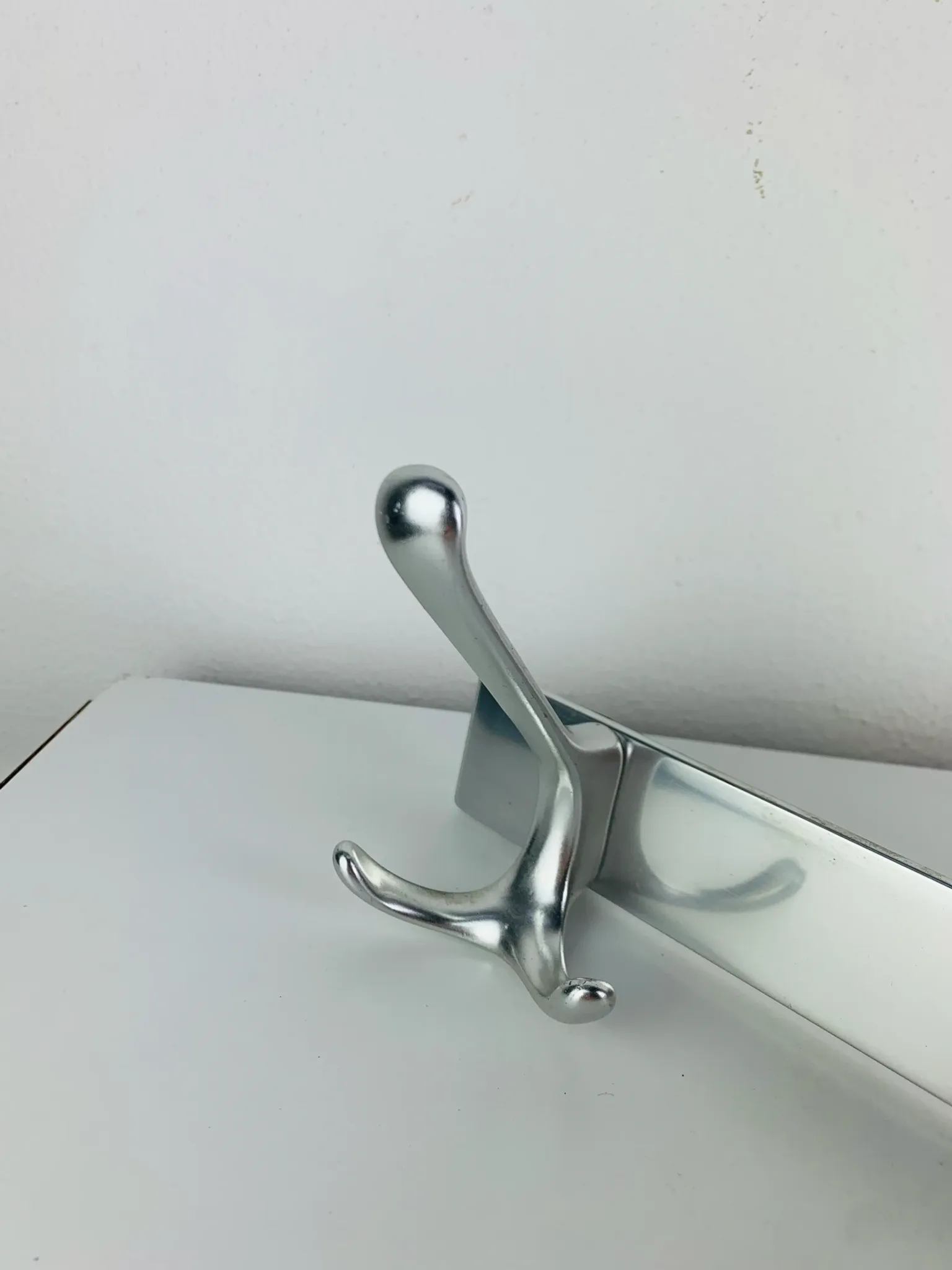 Wall-mounted coat rack, strip of 3 aluminium hooks from the 1960s.